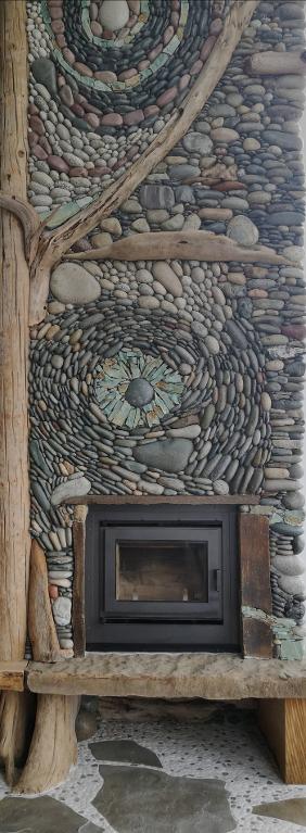 stone and wood chimney over wood burning fireplace