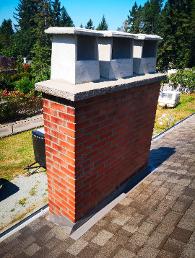 three concrete raincaps on a chimney